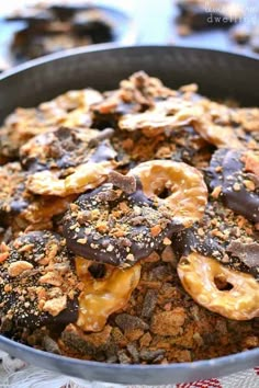 a pan filled with chocolate covered pretzels on top of a table