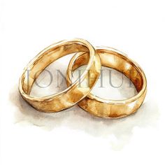 two gold wedding rings sitting next to each other