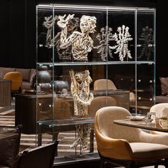 a glass display case filled with lots of different types of furniture and decor on top of a table