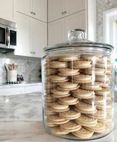 a jar filled with cookies sitting on top of a kitchen counter