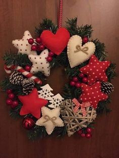 a christmas wreath with red and white ornaments