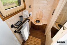 a small bathroom with wooden walls and flooring