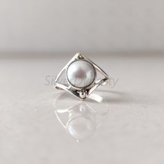 Stone : Pearl Metal : 925 Sterling Silver Stone Size : 8mm ( Can be customized as per your need) Shape : Round Band Size : 2mm Ships worldwide from India 925 stamped Handmade Item STYLE STATEMENT Be it ethnic or casual wear, this ring is sure to add style to your look. Match it with any attire and stay trending at all times. CUSTOMIZATION We welcome customization.Change in gemstone or design as per your need can be done. The stone size can also be changed as per your need. We are just a message Silver Sterling Pearl Ring, Unique Sterling Silver Pearl Promise Ring, Sterling Silver Open Pearl Ring With Polished Finish, Silver Stackable Open Pearl Ring, Unique Silver Pearl Promise Ring, Silver Open Pearl Ring For Jewelry Making, Silver Solitaire Pearl Ring For Promise, Sterling Silver Solitaire Pearl Ring For Anniversary, Silver Pearl Promise Ring With Round Band