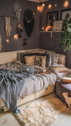 a bed room with a laptop on top of it next to a window and a rug