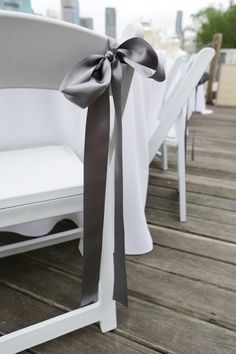 white chairs with black ribbon tied around them