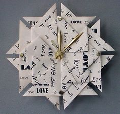 an origami clock made out of paper with words on it