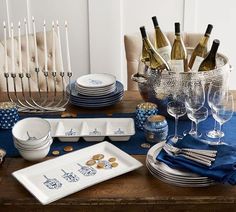 the table is set with wine glasses, plates and silverware for an elegant celebration