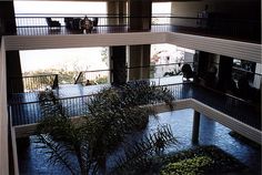 the inside of an apartment building with plants growing out of the floor and balconies