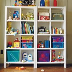 a white book shelf filled with lots of toys