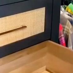 an oven door is open and there are other items in the drawer behind it on the counter