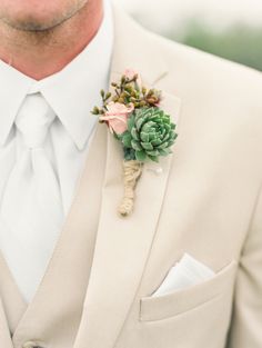 a man in a suit with a boutonniere on his lapel