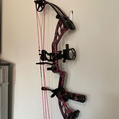 a bow that is mounted to the wall with two arrows on it and another arrow attached to the wall