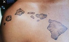 a man with a tattoo on his back that shows the map of the world in grey ink