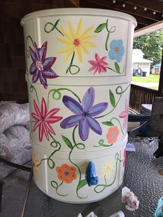 a painted trash can sitting on top of a table