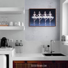 a kitchen with a sink, stove and shelves above it that have wine glasses on them