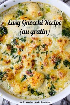 a casserole dish with cheese and spinach in it on a marble table