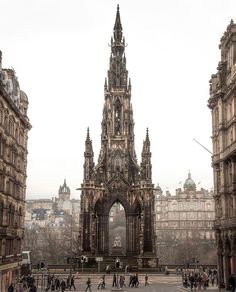 people are walking around in front of an old building