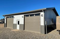 two garages are shown in the middle of a gravel lot with one door open