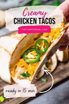 a person holding a wrap filled with chicken tacos