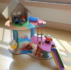 a toy house with toys on top of it