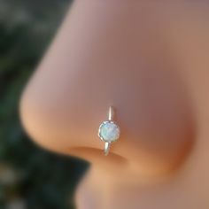 a close up view of a ring with an opal stone on it's side