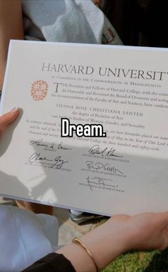 a person holding up a diploma in front of the camera with words above it that read, dream