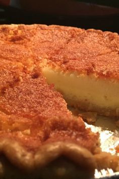 a close up of a pie on a pan with one slice cut out and ready to be eaten