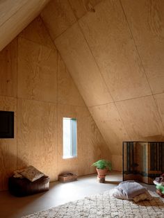 a room with wooden walls and a rug on the floor