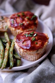 some food on a white plate with green beans