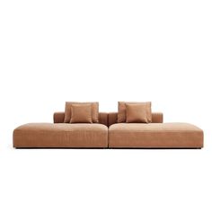 a large brown couch sitting on top of a white floor