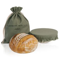 two loaves of bread sitting next to a bag with the word homemade with love written on it