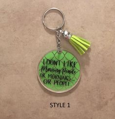 a green keychain with the words i don't like morning people or mornings or people on it