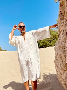 Hand made From start to finish Linen and cotton mixed lightweight fabric night gown for men Mens natural fabric caftan It's a special kind of linen which is only made in Anatolia ( i uploaded the fabric's detailed picture ) Lightweight White color Plus size avalible Small/medium/large/ xlarge / 2XL / 3XL / 4XL / 5XL size options Feel free to Ask for custom made Front pocket - kangaroo pocket Gift for him Super comfortable men's clothing to wear at home or outdoor Linen outfit Nightgown Pool part Traditional Linen Kaftan For Summer, Casual Tunic Thobe For The Beach, Casual Long Thobe For The Beach, Casual Summer Vacation Thobe, Casual Long Thobe For Vacation, Summer Festival Thobe Tunic, Summer Festival Tunic Thobe, Casual Summer Tunic Thobe, White Long Thobe For Summer