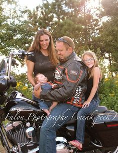 a man, woman and child sitting on a motorcycle