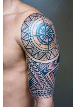 a man's half sleeve tattoo with geometric designs on his left arm and shoulder