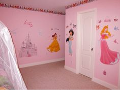 a bedroom decorated in pink with princess wall decals