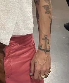 a woman with tattoos on her arm holding onto a brown bag