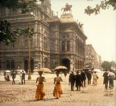 an old photo of people walking down the street