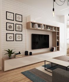 a living room filled with furniture and a flat screen tv on top of a wooden shelf