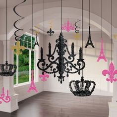 a chandelier with pink and black decorations hanging from it's ceiling in front of a window