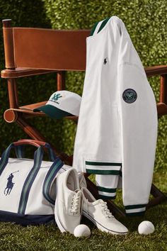 a pair of white shoes sitting on top of a wooden bench next to a bag