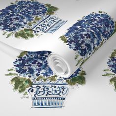 a blue and green wallpaper with flowers on the top, in front of a white background