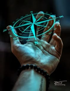 a person holding a compass in their hand