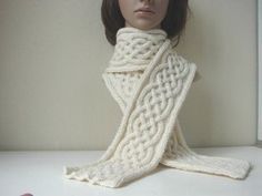 a mannequin wearing a white knitted scarf