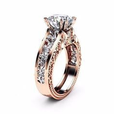 a rose gold engagement ring with an intricate filigreet design on the side