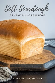 a loaf of bread sitting on top of a cutting board with the words soft sourdough sandwich loaf bread