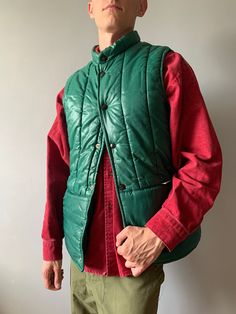 Quilted Waistcoat / Moncler Style / Eddie Bauer / Quilted Vest /  Down Jacket / Puffer Down Jacket / Size M / 1980s  This vintage quilted vest in good condition, several small holes (please, look photo) - made in United Kingdom - brand - Clifton - ERA 1980's - color - green - 2 outside pockets - 7 stud buttons Scovill - material - 100% nylon - label size - M (watch measurements) FLAT Measurements: Shoulders: 39cm Chest (underarm to underarm): 52cm Length(back): 69cm Pay your attention to that  m Mens Quilted Jacket, Vintage Vest For Outdoor Fall Activities, Retro Green Outerwear For Outdoor, Retro Green Outerwear For Outdoors, Green Vintage Vest For Fall, Fitted Vintage Outdoor Outerwear, Vintage Green Vest For Fall, Vintage Outdoor Vest For Fall, Vintage Green Outerwear For Cold Weather