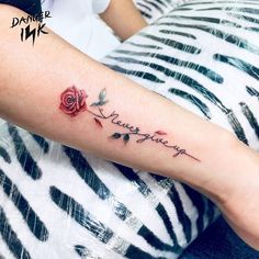 a woman's arm with a rose and the words love you written on it