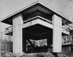 an old black and white photo of a building with stairs going up to it's roof