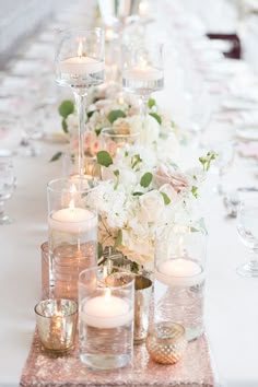 a long table with candles and flowers on it